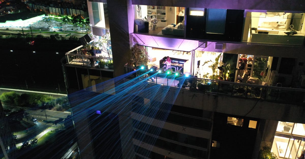Does the blue highlight indicate anything? [duplicate] - Modern skyscraper with glowing laser projectors at night