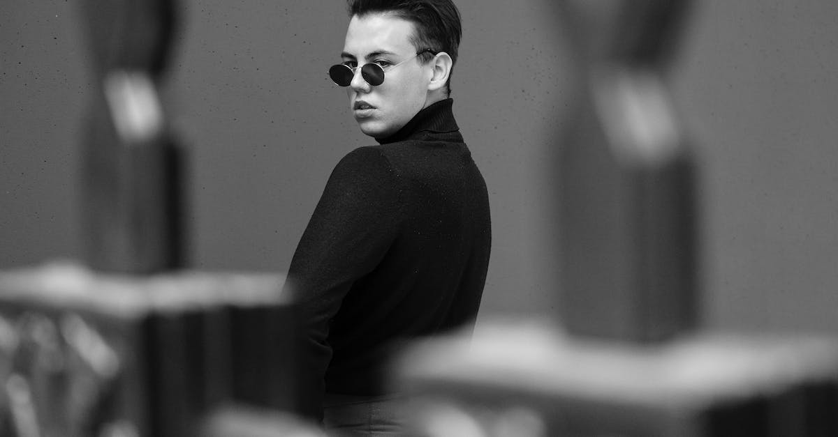 Does the Empire have any advantages over the Rebel Alliance, or vice versa? - Black and white trendy arrogant male in black turtleneck and sunglasses standing behind balustrade and looking at camera over shoulder with attitude