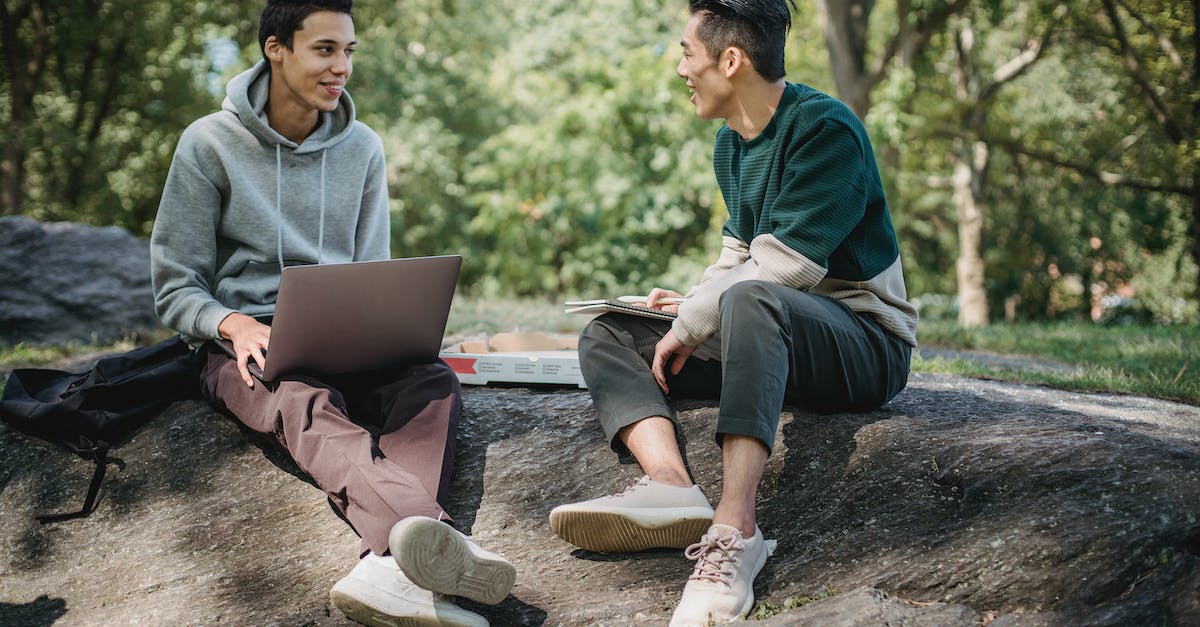 Does the Exp. Share also spread EVs to other members of the team? - Full body of positive multiracial classmates sharing information on university assignment while browsing laptop in nature