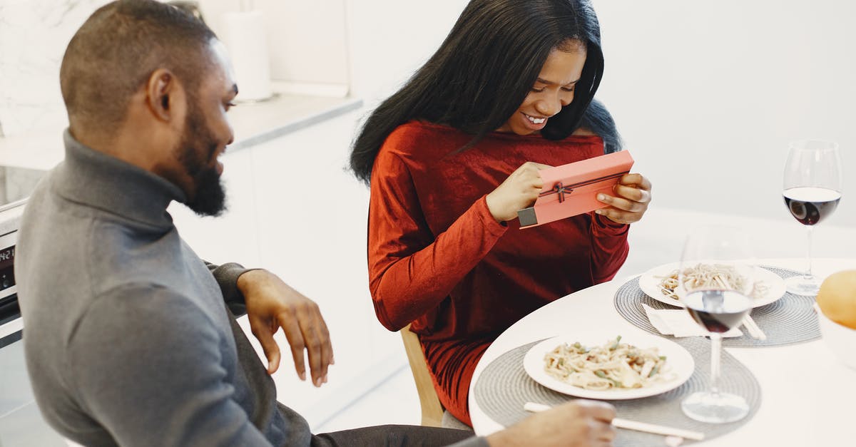 Does the food I provide affect which kitties visit? - Woman Opening Her Valentines Day Gift During a Romantic Dinner 