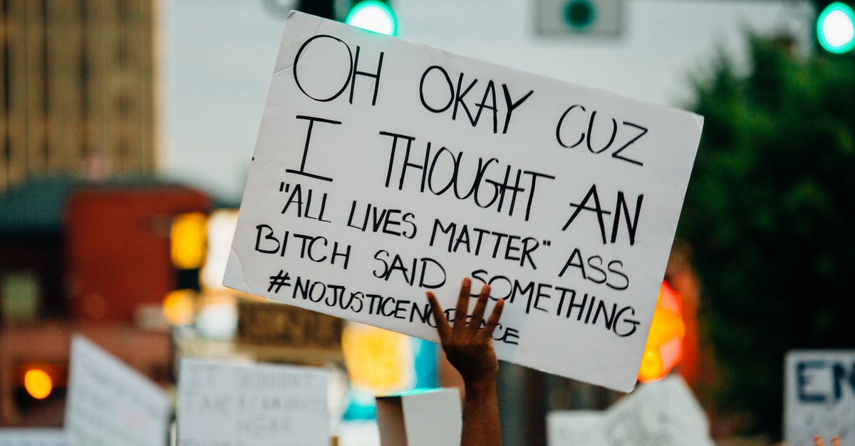 Does the global timer matter? - Faceless black person holding banner during demonstration on street