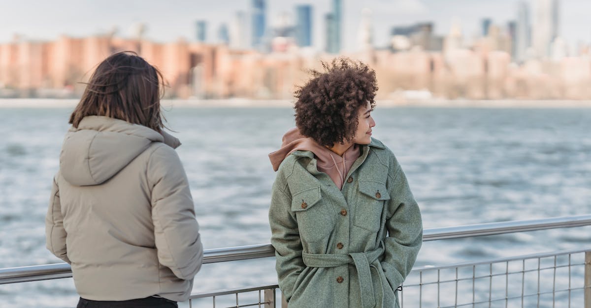 Does the Last of Us season pass include a multiplayer key? - Young female friends wearing warm clothes standing together with hands in pockets on New York City promenade on cold day