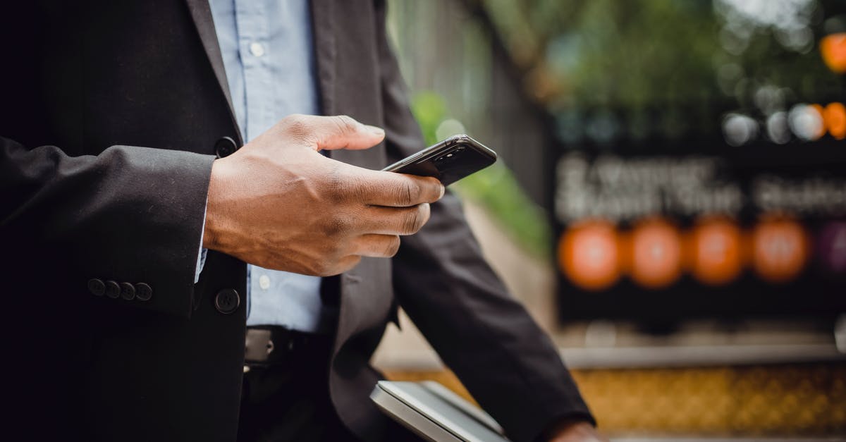 Does the Logitech Extreme 3D Pro work with Windows 10 metro app games? - Crop black businessman using smartphone on street