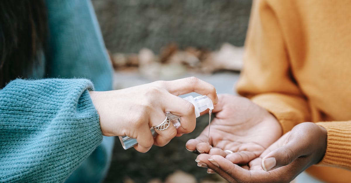 Does the Name Engraved Ring help or hinder general Coop? - Crop woman pouring antiseptic on hands Does the Name Engraved Ring help or hinder general Coop? - Crop woman pouring antiseptic on hands