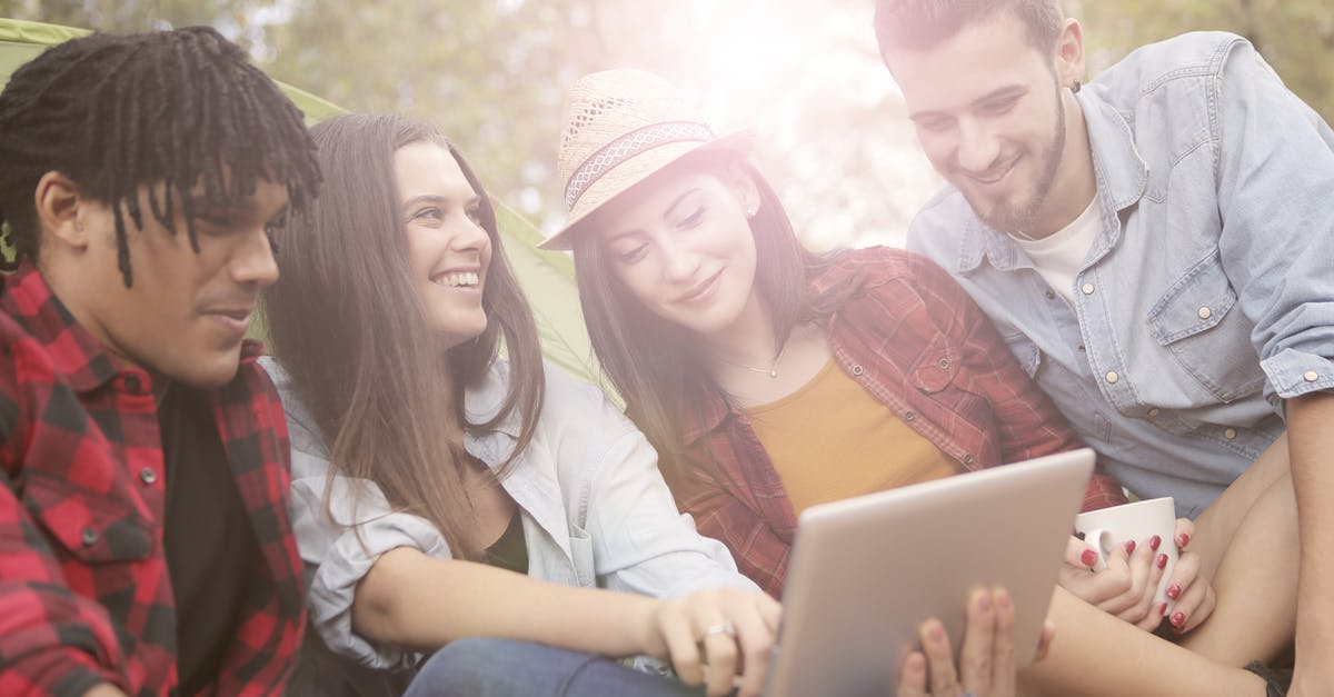 Does the Nintendo Switch Online Family Group allow sharing of eShop games between accounts on different devices? - Cheerful friends browsing laptop in forest Does the Nintendo Switch Online Family Group allow sharing of eShop games between accounts on different devices? - Cheerful friends browsing laptop in forest