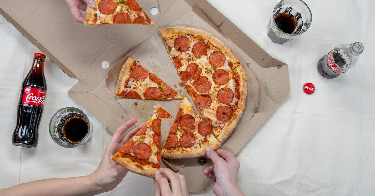 Does the Nuka-Cola bottler actually generate nuka cola? - Person Holding Pizza on White Box