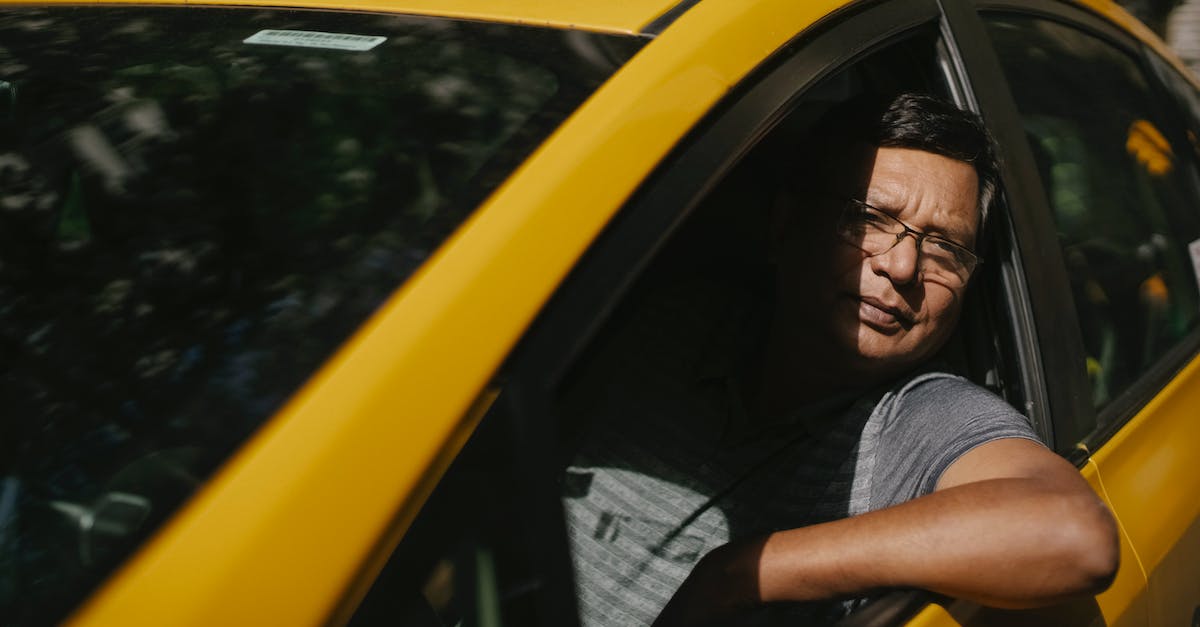 Does the Playstation Move 'Wand' work with the PS4 camera? - Adult male driver in glasses sitting in yellow cab and working while looking at camera