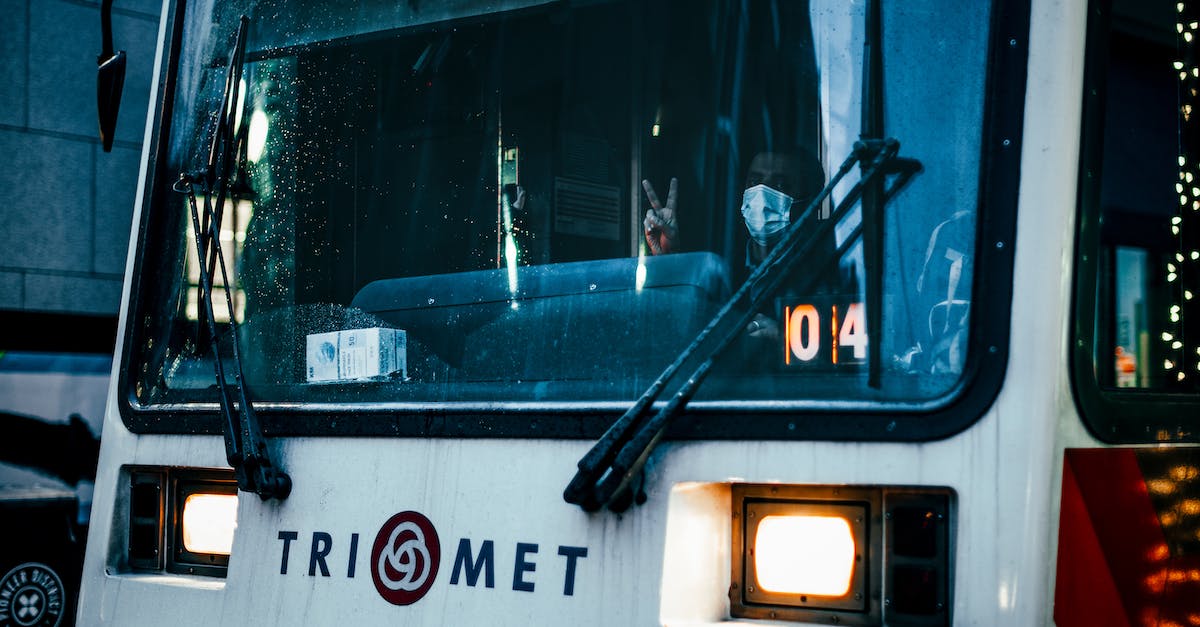 Does the Playstation Move 'Wand' work with the PS4 camera? - Through windshield glass of unrecognizable male driver of public transport in medical mask looking at camera and showing two fingers gesture