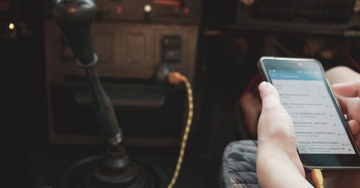 Does the PS VITA AC Adapter works with the old PSP? - Crop person in car browsing smartphone