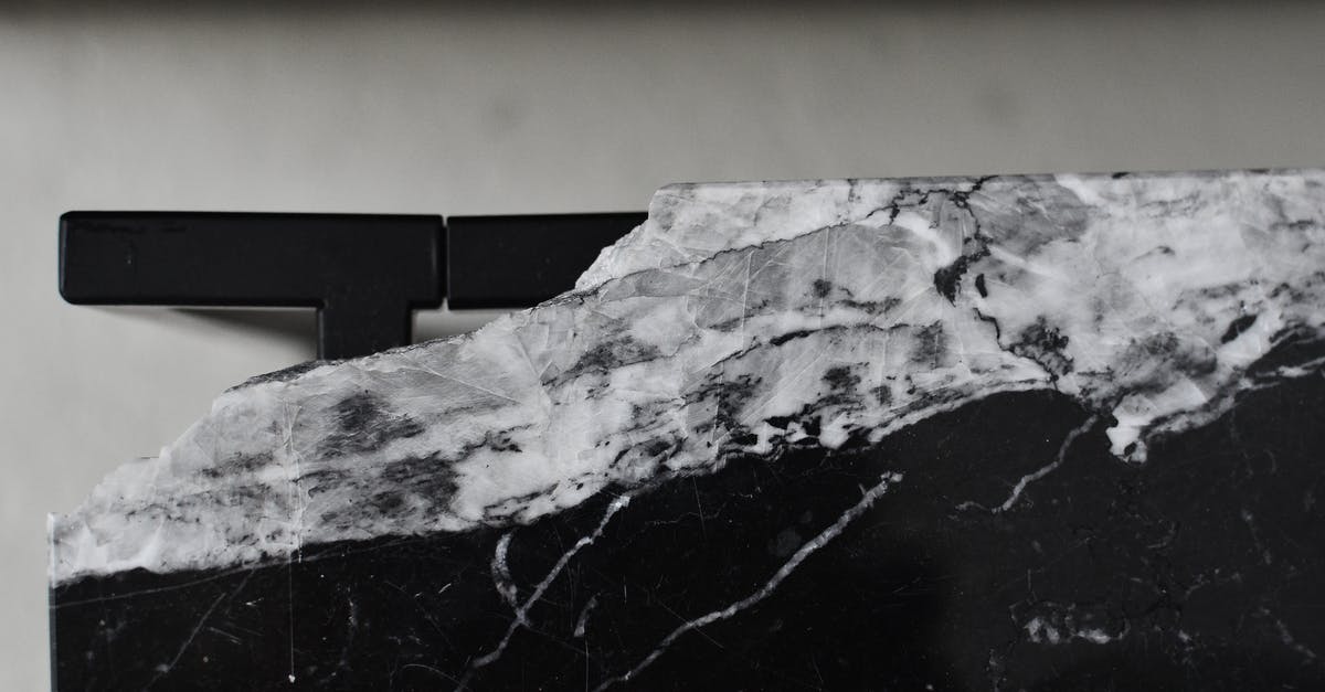 Does the room level affect how much damage deathclaws will do in a room? - Top view of aged table with damaged marble surface on floor in house room in daylight