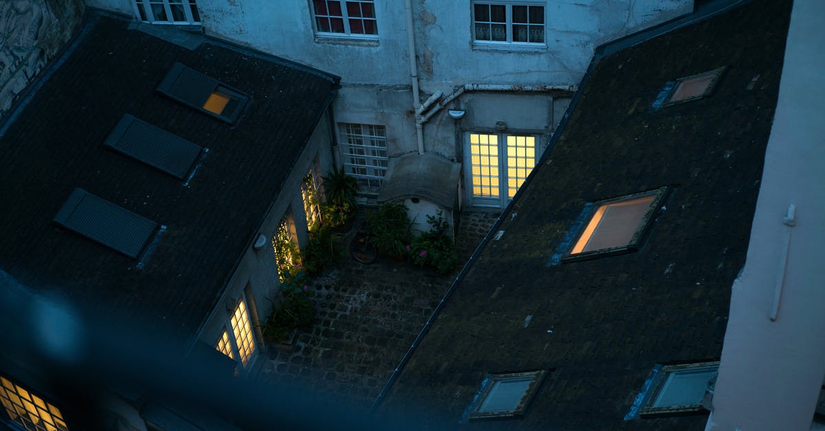 Does the (Small) Ring of Glow prevent me from catching Night Fish? - Small backyard with lit windows in twilight viewed from balcony