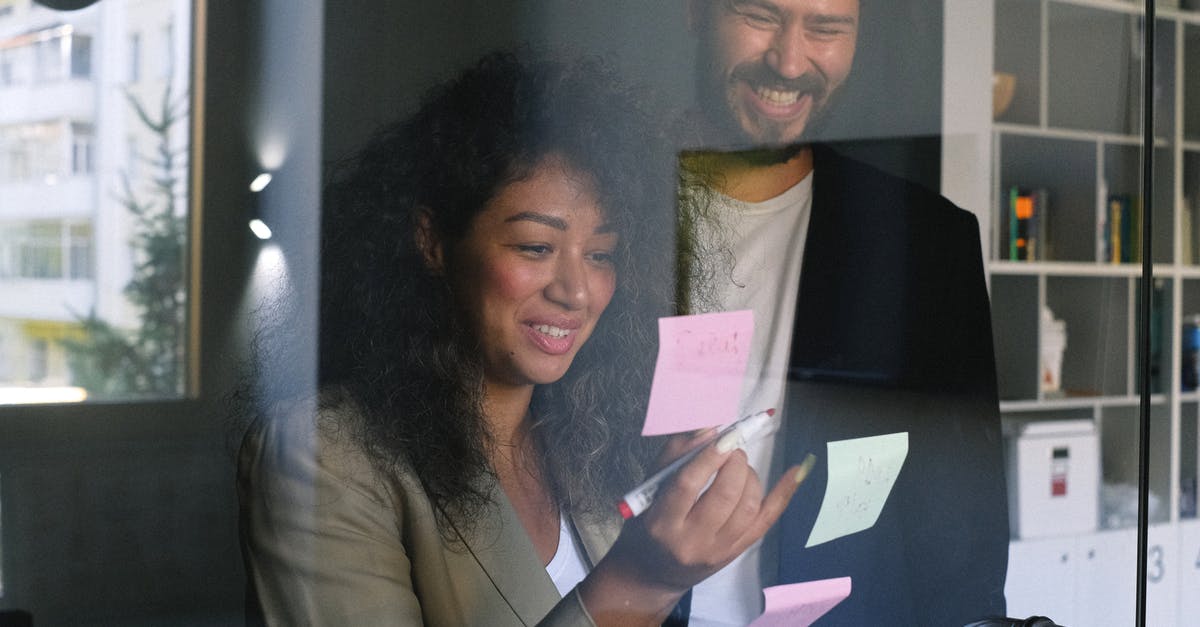 Does the sticker counter include duplicate stickers? - Diverse happy business partners checking stickers on glass door and smiling together in office Does the sticker counter include duplicate stickers? - Diverse happy business partners checking stickers on glass door and smiling together in office