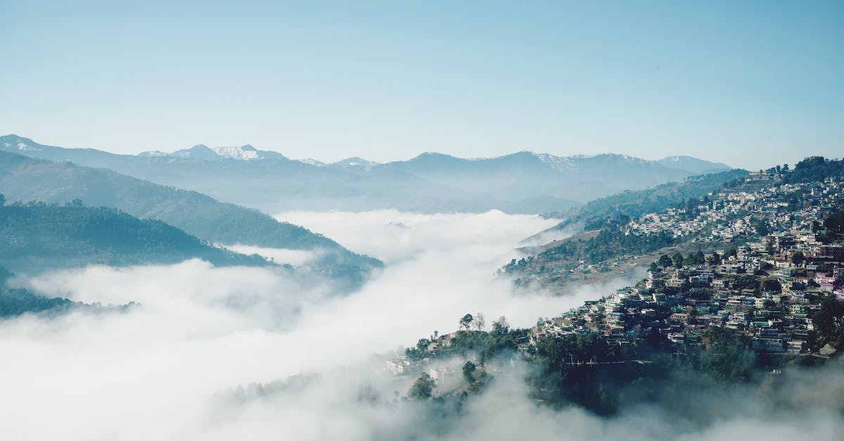 Does the throwing distance of thrown melee weapons get effected by range mods? - Peaceful landscape of remote town on slope of green mountain in highland valley covered with fog