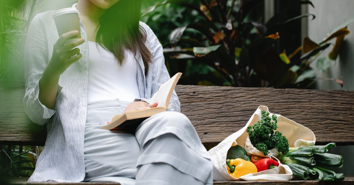 Does the warmonger penalty go down over time? - Crop happy Asian woman reading book on bench in garden