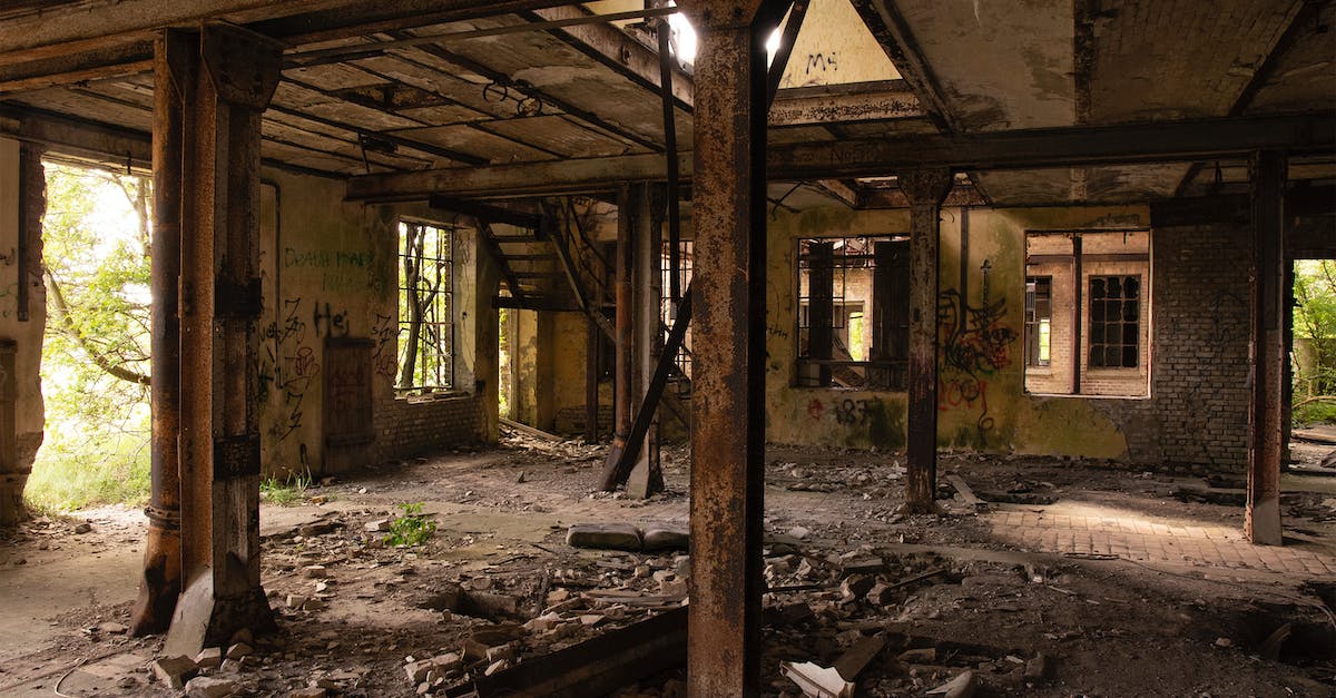 Does Thorns damage trigger Area Damage? - Weathered industrial building with metal columns and ruins on floor located near tress on sunny day