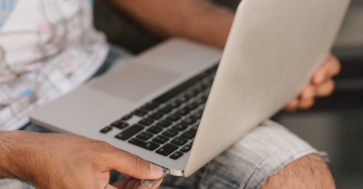 Does using an HDMI splitter introduce input lag? - Crop faceless man using laptop and inserting flashcard Does using an HDMI splitter introduce input lag? - Crop faceless man using laptop and inserting flashcard