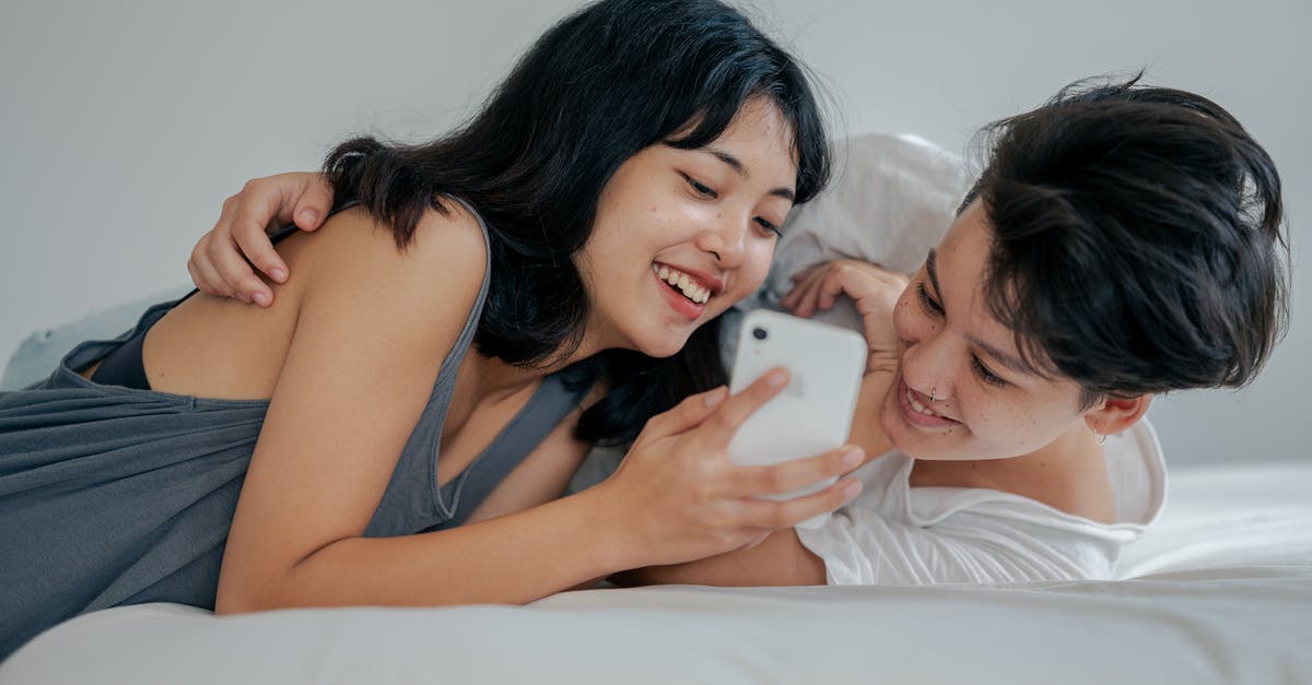Does using explosives affect resources gathered on downed UFO missions? - Photo of Couple Lying on Bed While Using Smartphone