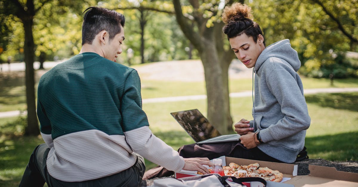 Does using explosives affect resources gathered on downed UFO missions? - Diverse students eating pizza while studying with laptop in park