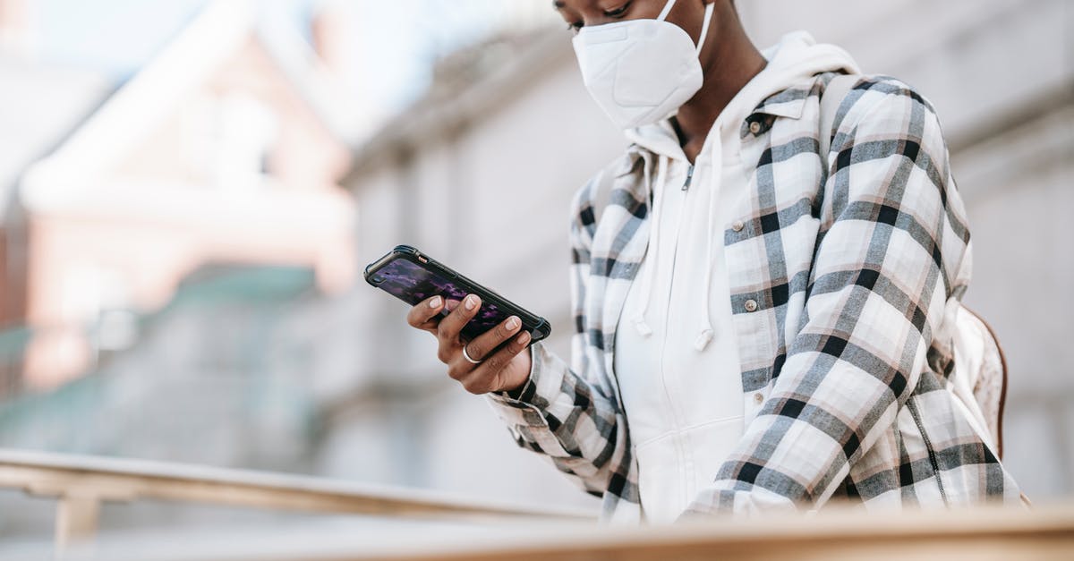 Does using laser weapons prevent you from collecting weapon fragments? - Black woman using smartphone on city street