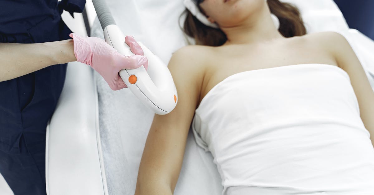 Does using laser weapons prevent you from collecting weapon fragments? - From above of unrecognizable cosmetologist in uniform and latex gloves using modern equipment for cosmetic services in contemporary salon