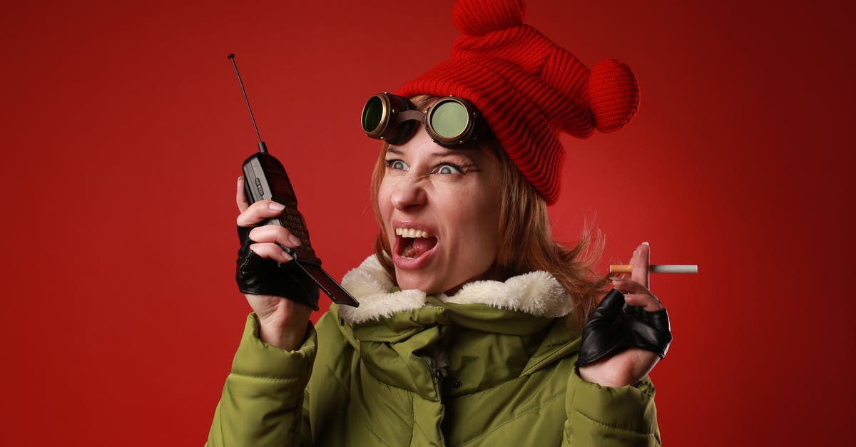 Does using the radio alert enemies to my presence? - Annoyed female model in outerwear with old goggles yelling into walkie talkie while looking away on red background Does using the radio alert enemies to my presence? - Annoyed female model in outerwear with old goggles yelling into walkie talkie while looking away on red background