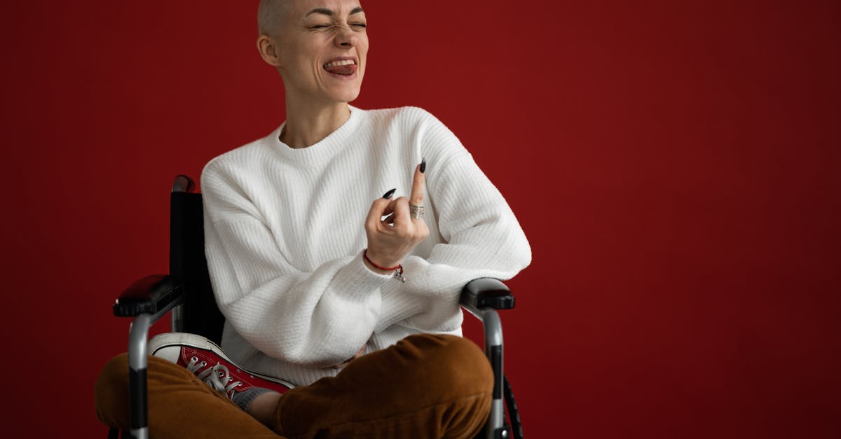 Does Zimos have throat cancer? - Female in wheelchair grimacing with tongue out and middle finger Does Zimos have throat cancer? - Female in wheelchair grimacing with tongue out and middle finger