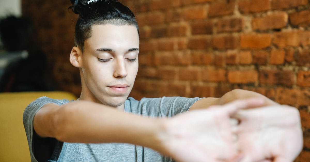 Don't have the needed software to perform this action? - Young male athlete with creative hairstyle cracking knuckles and closing eyes while doing exercise Don't have the needed software to perform this action? - Young male athlete with creative hairstyle cracking knuckles and closing eyes while doing exercise