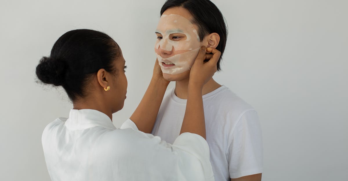 Don't Starve Together - how to find each other - African American female beautician applying moisturizing mask on face of young ethnic man while looking at each other on light background Don't Starve Together - how to find each other - African American female beautician applying moisturizing mask on face of young ethnic man while looking at each other on light background
