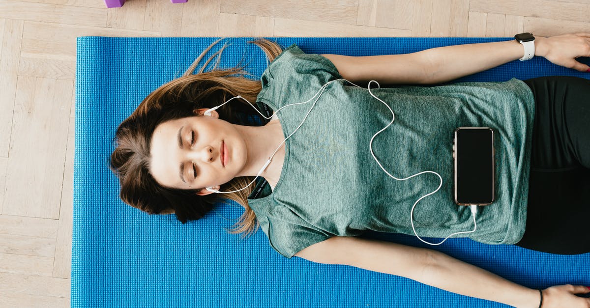 Doom blue screen of death (BSOD) - Peaceful woman in earphones resting in Shavasana pose at home Doom blue screen of death (BSOD) - Peaceful woman in earphones resting in Shavasana pose at home