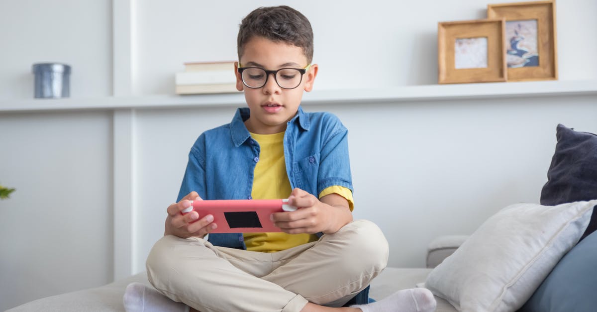 Dota 2 Reborn: Stop Console Command - Boy in Blue Dress Shirt and Gray Pants Sitting on White Couch