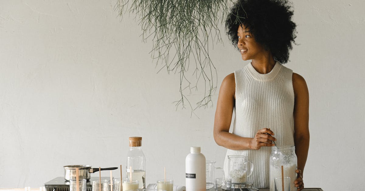 Dota 2 Workshop Content downloading, DLC unticked - Content African American female artisan with jar of wax flakes looking away while creating candles in modern workshop in light room