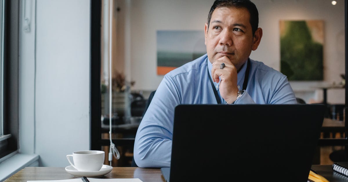 Dragon Boss strategy? - Thoughtful ethnic businessman using laptop while working in office Dragon Boss strategy? - Thoughtful ethnic businessman using laptop while working in office