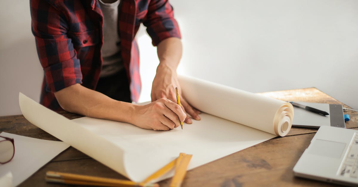 Draw in the empire - Male constructor drawing draft on paper roll Draw in the empire - Male constructor drawing draft on paper roll