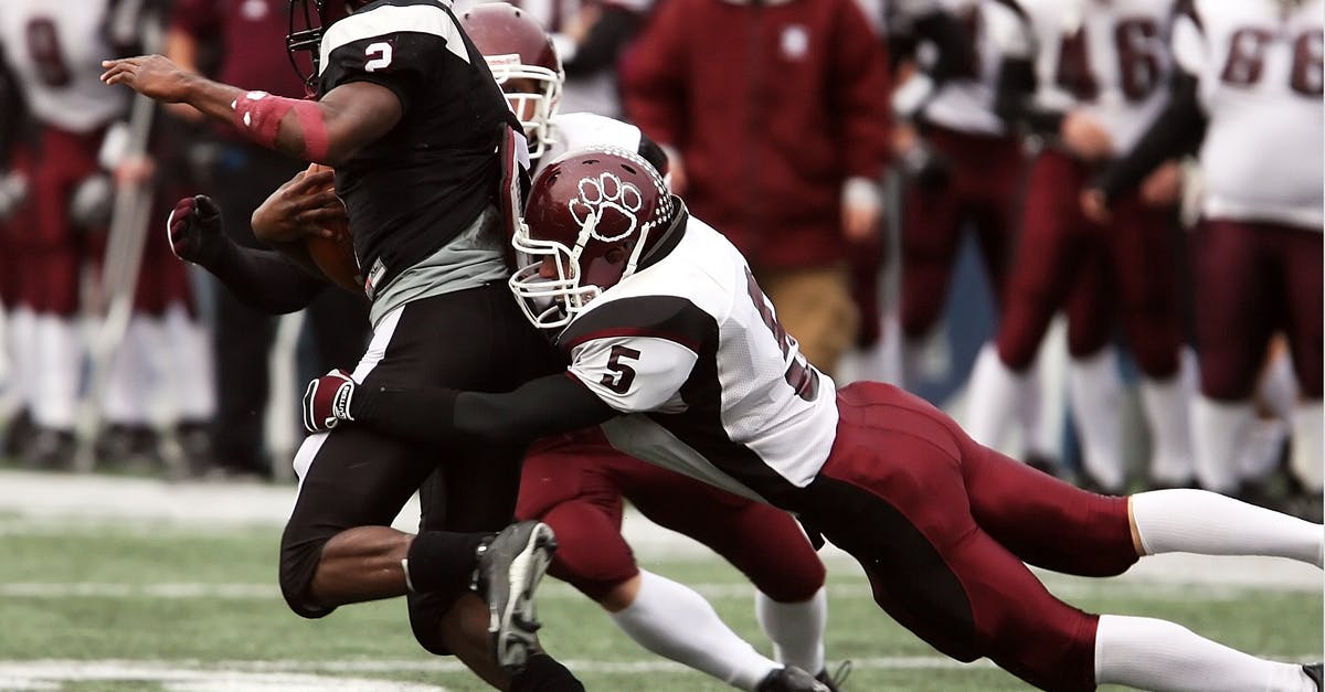Duration of defensive pacts in late game - 3 Football Players Playing on the Stadium
