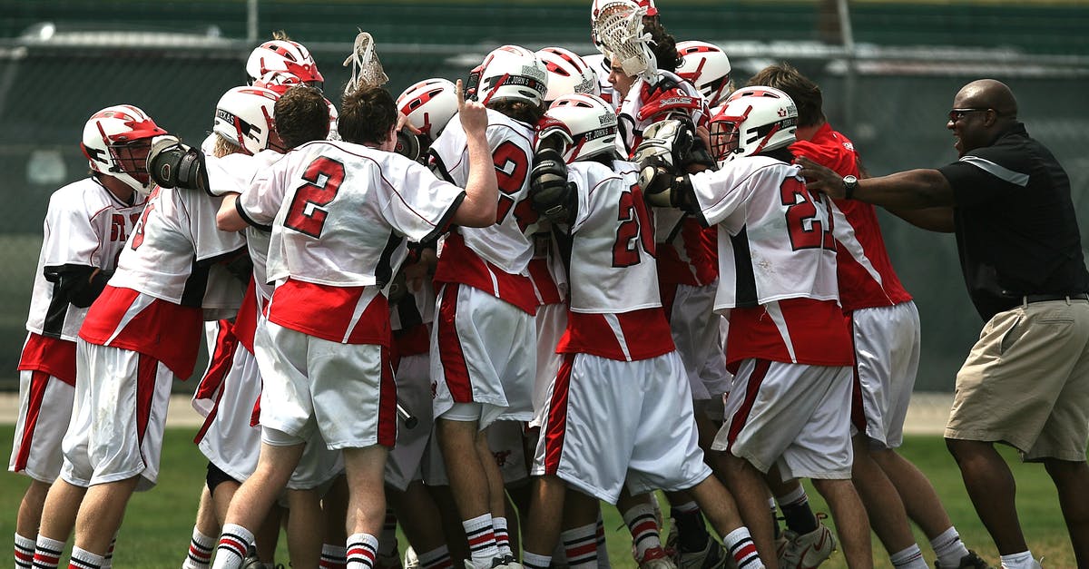 Duration of defensive pacts in late game - Group of Lacrosse Players Celebrating With Coach during Daytime