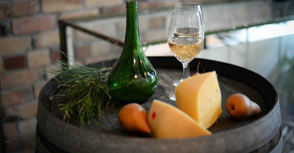 Dwarves not drinking booze in barrels right next to them - High angle of glass bottle with wineglasses placed on barrel with aromatic cheese and pears Dwarves not drinking booze in barrels right next to them - High angle of glass bottle with wineglasses placed on barrel with aromatic cheese and pears