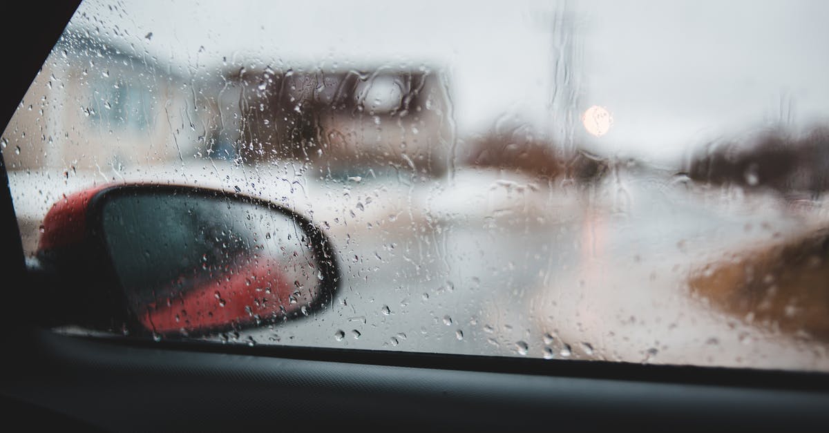 Easiest/cheapest way to light a redstone lamp when mobs fall through tunnel onto hoppers - View of street with houses and road through wet car window on rainy day in autumn