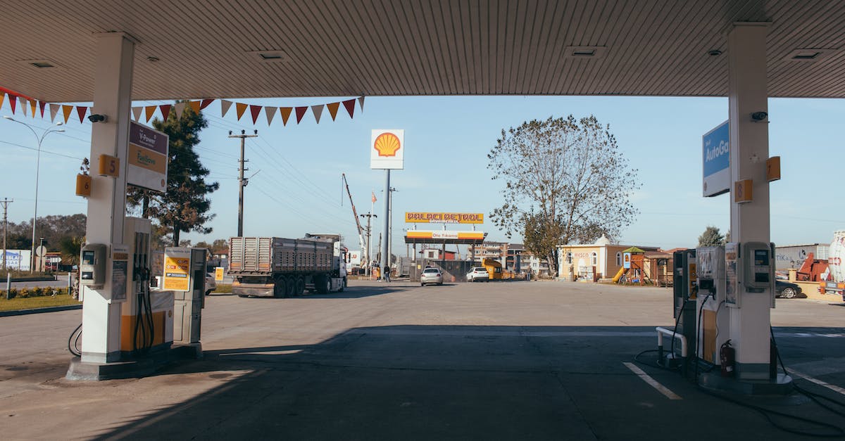 Economical route and fuel scooping - Empty gas station with oil petrol dispensers located on highway for serving long distance vehicles