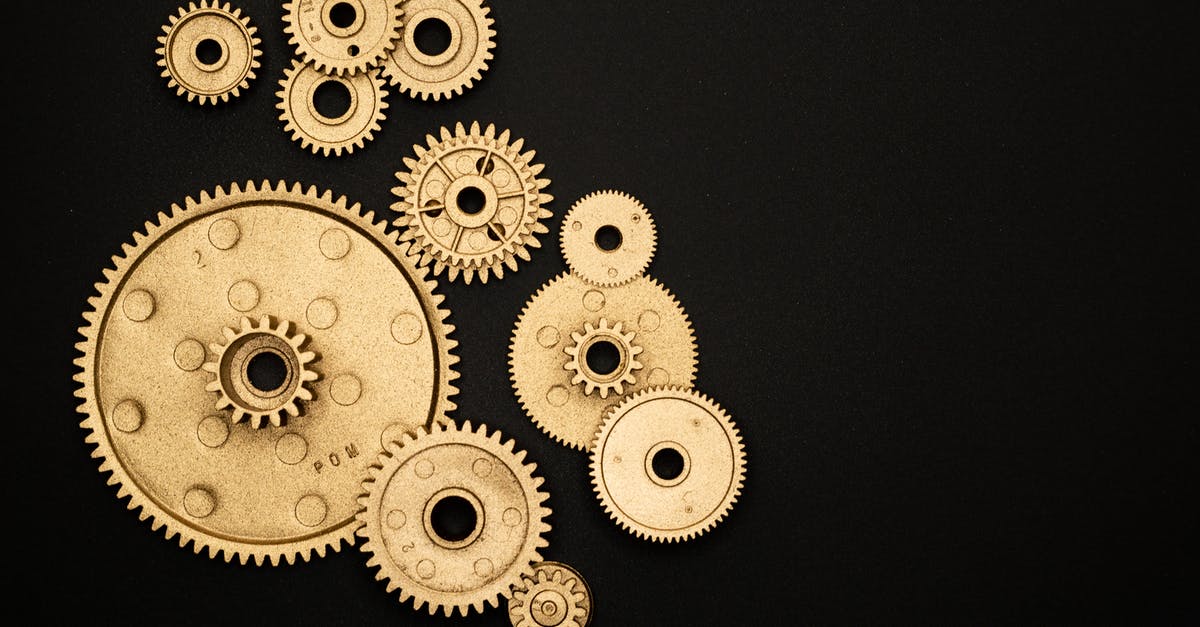 Elytra mechanics in Minecraft - Photo of Golden Cogwheel on Black Background