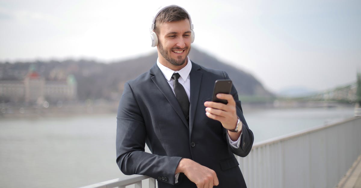 Employees randomly drown themselves in nearby lake - Man in Black Suit Jacket Holding Black Smartphone Employees randomly drown themselves in nearby lake - Man in Black Suit Jacket Holding Black Smartphone
