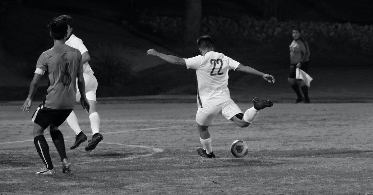 Enchant Property: Damage vs. Attack Speed % - Man kicking ball during football match in park Enchant Property: Damage vs. Attack Speed % - Man kicking ball during football match in park