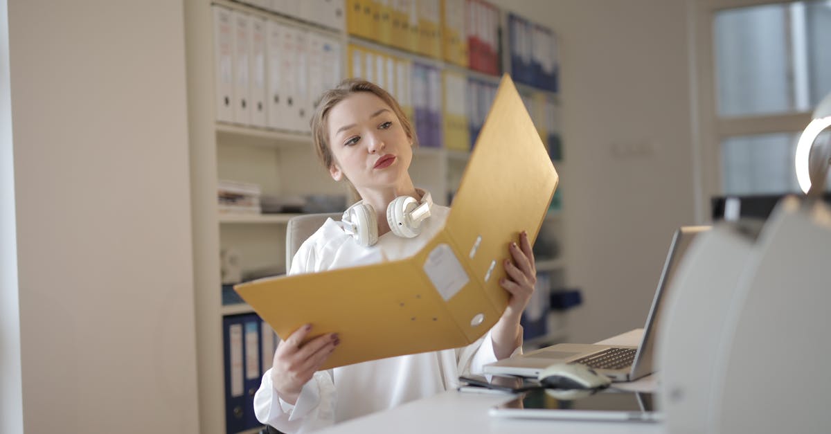 End data folder location - Thoughtful female office worker with folder in workplace End data folder location - Thoughtful female office worker with folder in workplace