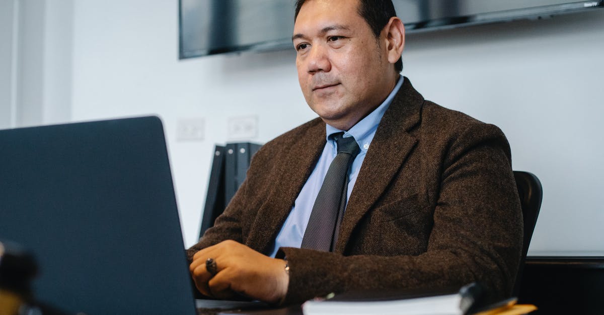 Enigma data pack in the Royal Hotel's ballroom is inaccessible - Focused ethnic businessman using netbook while working in office Enigma data pack in the Royal Hotel's ballroom is inaccessible - Focused ethnic businessman using netbook while working in office