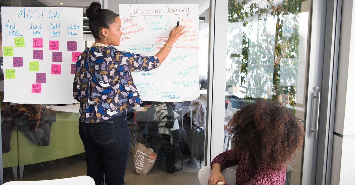 EV training not working? [duplicate] - Two Women Having a Meeting Inside Glass-panel Office