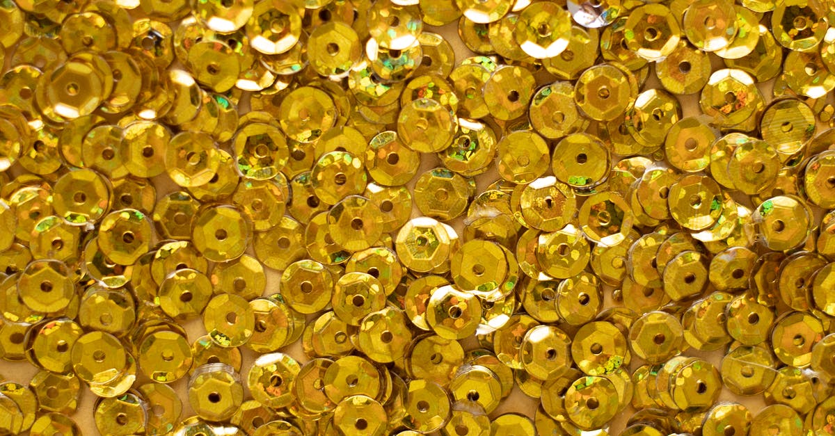 Exactly how rare are golden snowmen, and is snowmen placement random or fixed? - Top view of closeup of golden shiny round shaped rhinestones randomly placed on surface