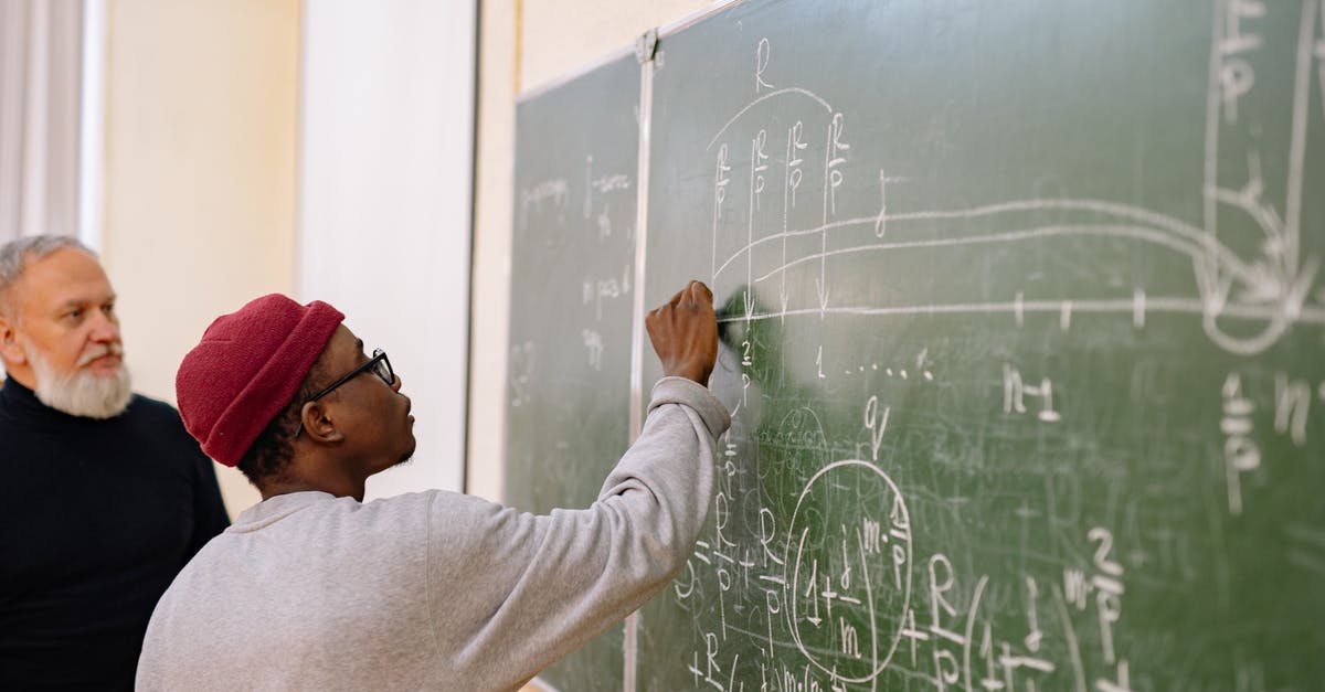 /execute questions - Student Answering the Questions on a Black Board /execute questions - Student Answering the Questions on a Black Board