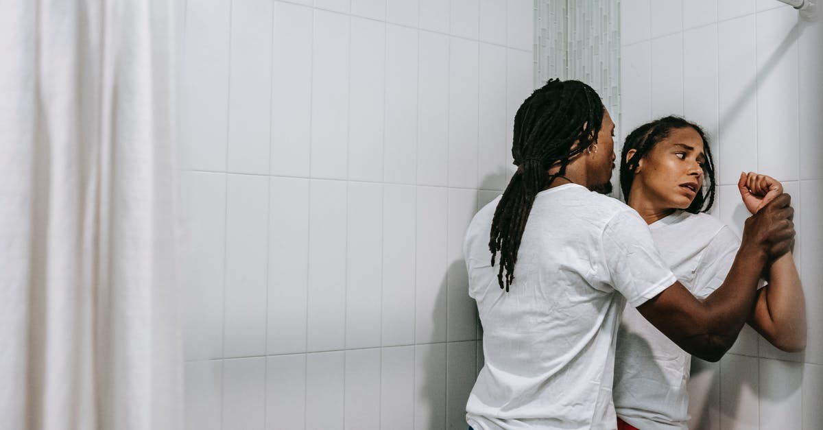 expeditionary force problem - Angry African American man with dreadlocks grabbing hands of scared woman and pressing against tiled wall during argument in bathroom expeditionary force problem - Angry African American man with dreadlocks grabbing hands of scared woman and pressing against tiled wall during argument in bathroom