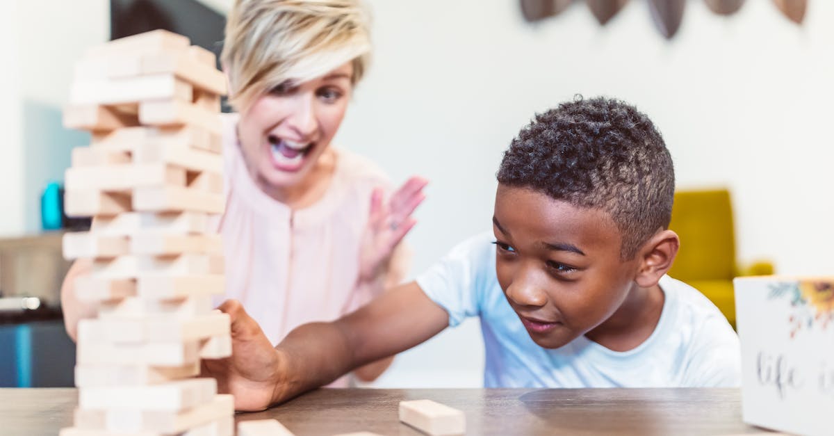 Expieriencing Block\Tick Lag - Woman Cheering Boy While Playing Jenga 
