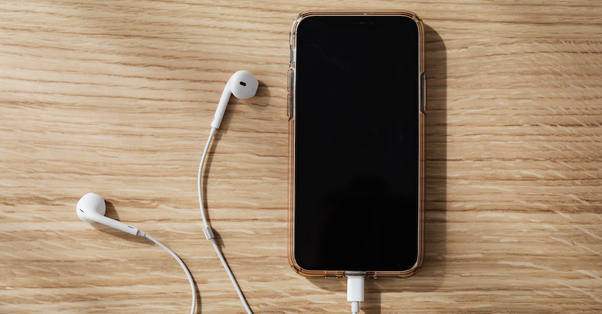 Extracting any kind of information from the app - Charging smartphone and white earphones on wooden table