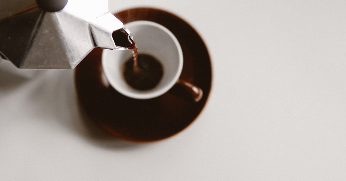 Factorio: How to fill belts on-demand? - From above of geyser coffee maker pouring freshly brewed beverage into ceramic cup placed on white table Factorio: How to fill belts on-demand? - From above of geyser coffee maker pouring freshly brewed beverage into ceramic cup placed on white table